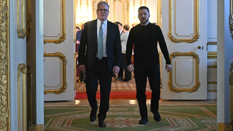 Ukraine's President Volodymyr Zelensky and Prime Minister Sir Keir Starmer head to a private room to hold a meeting during a Leaders' Summit on the situation in Ukraine at Lancaster House, London. Picture date: Sunday March 2, 2025.
